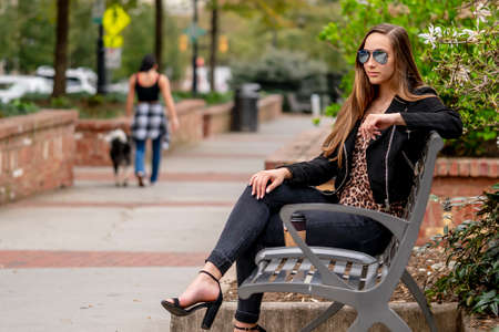 A gorgeous brunette model poses outdoors while enjoying the spring weather