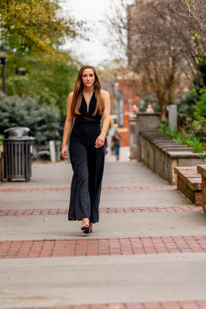 A gorgeous brunette model poses outdoors while enjoying the spring weatherの写真素材