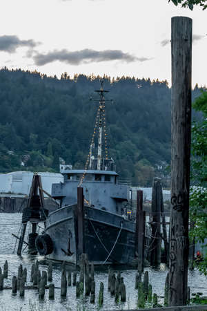 A old abandoned vessel sits on the dock near a riverのeditorial素材