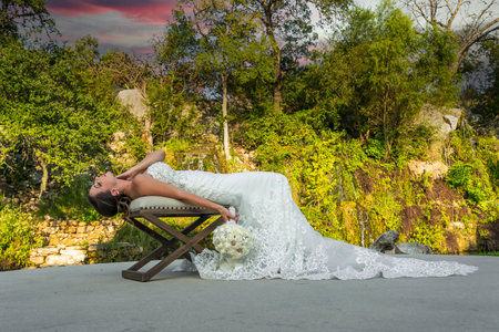 A gorgeous brunette bride poses in her wedding dress before the big dayの写真素材