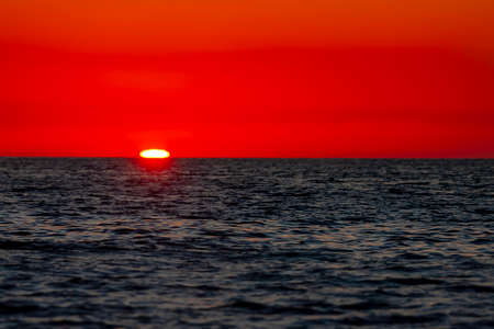 The sun rises on the Pacific Ocean in Baja Californiaの写真素材