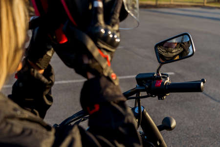 A gorgeous blonde model enjoys the outdoors while driving her motorcycle.の写真素材