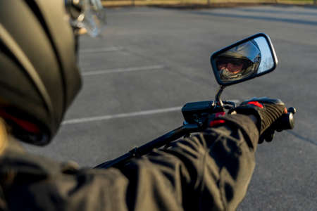 A gorgeous blonde model enjoys the outdoors while driving her motorcycle.の写真素材