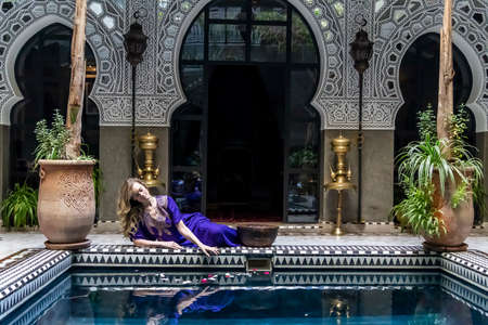 A gorgeous model poses inside a home environment in Medina, Morocco, Africa