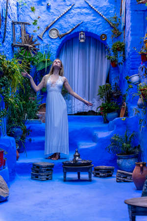 A model poses in the Blue City of Chefchaouen, Morocco, Africaの写真素材
