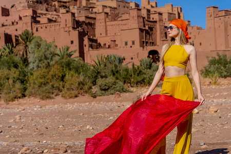 A gorgeous model poses outdoors near of Ait Ben Haddou,  in Morocco, Africa
