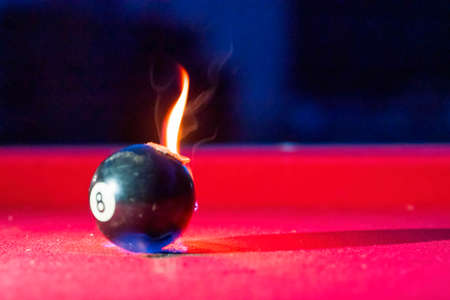 Billiard balls are photographed on fire while sitting outdoors in an open environmentの写真素材
