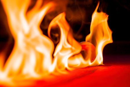 Billiard balls are photographed on fire while sitting outdoors in an open environmentの写真素材