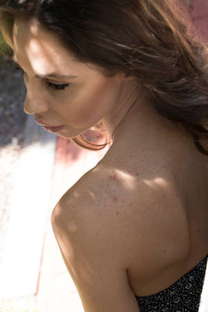 A beautiful brunette bikini model posing outdoors in an urban environmentの写真素材