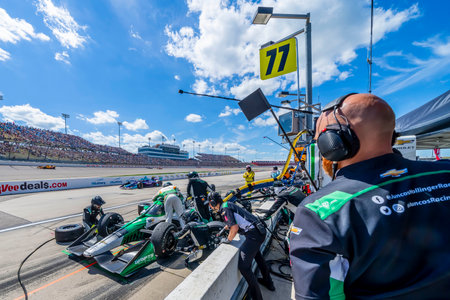 CALLUM LLOTT (77) (R) of Cambridge, England brings his car in for service during the HY-VEEDEALS.COM 250 at Iowa Speedway in Newton IA.のeditorial素材