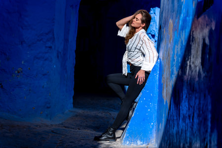 A model poses in the Blue City of Chefchaouen, Morocco, Africaの写真素材