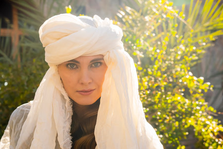 A beautiful model wears a hijab in the middle of the Sahara desertの写真素材