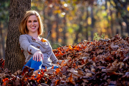 A gorgeous blonde model enjoys the outdoor fall weather