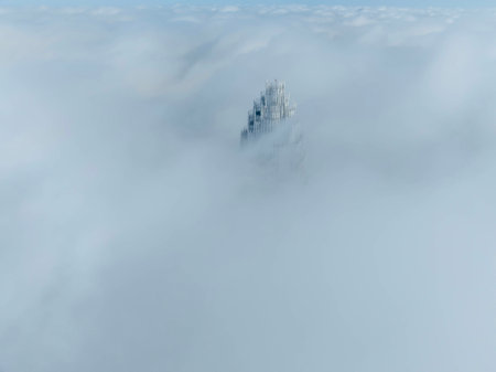 Aerial view of a commercial building against a foggy sky in the American South