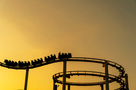 Silhouette of a roller coaster at sunset on a California coastlineの写真素材