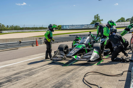 AGUSTIN HUGO CANAPINO (R) (78) of Arrecifes, Argentina brings his car in for service during the Childrens of Alabama Indy Grand Prix at Barber Motorsports Park in Birmingham AL.のeditorial素材