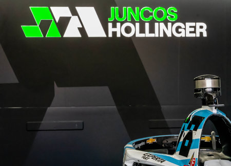Crew members of Juncos Hollinger Racing prepare their race car for the Indianapols 500 in...