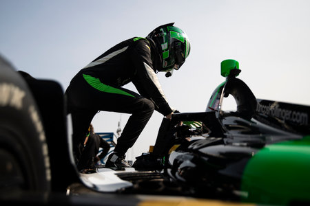 CALLUM ILOTT (77) of Cambridge, Cambridgeshire, England climbs into their car on pit road during a...