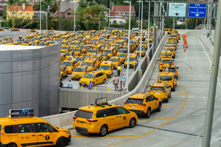 Yellow taxi cabs wait in line at LaGuardia Airport before picking up their fares.