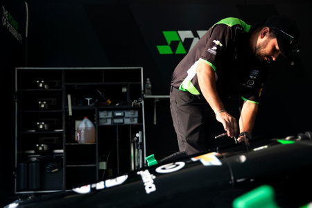 The crew of Juncos-Hollinger Racing work on the car prior to practice for the Sonsio Grand Prix at...