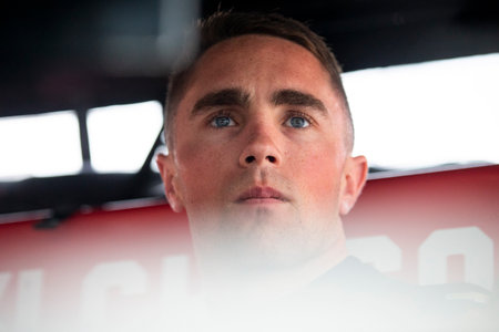 BENJAMIN PEDERSEN (R) (55) of Copenhagen, Denmark suits up on pit road prior to a practice for the...