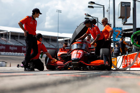 The crew of AJ Foyt Racing  work on the car on pit road during practice for the HyVee Indycar Weekend  at Iowa Speedway in Newtown IA.のeditorial素材