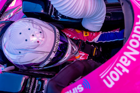 INDYCAR Series driver, LINUS LUNDQVIST (R) (60) of Stockholm, Sweden, straps into his car for the Firestone Grand Prix of Monterey at WeatherTech Raceway Laguna Seca in Monterey, CA.のeditorial素材