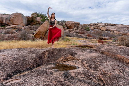 A gorgeous brunette model poses outdoors while enjoying the autumn weatherの写真素材
