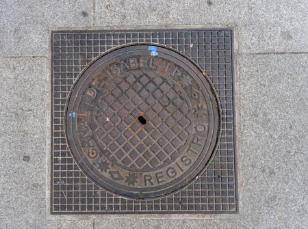 Madrid manhole cover on a busy street in Madrid, Spain