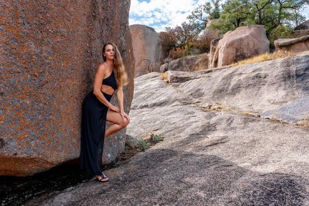 A gorgeous brunette model poses outdoors while enjoying the autumn weatherの写真素材
