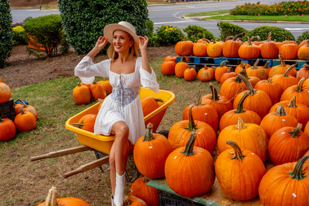 A beautiful European blonde female pics out some pumpkins and flowers for the upcoming fall...