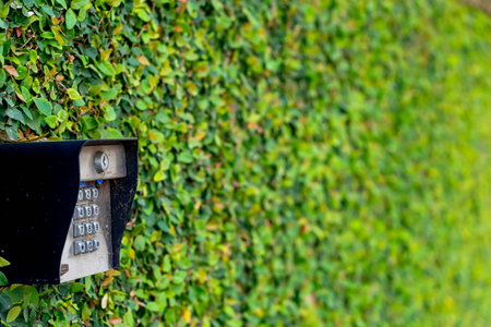 Entrance gate to a beautiful gated residential house community with lush green trees and grassEntrance gate to a beautiful gated residential house community with lush green trees and grassの写真素材