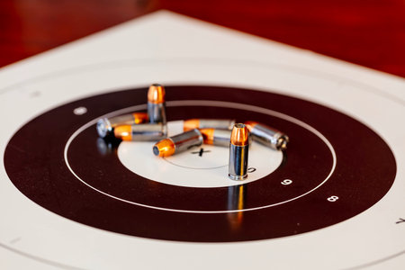 Silent anticipation as bullets rest on the target, prelude to the rhythmic dance of precision about...