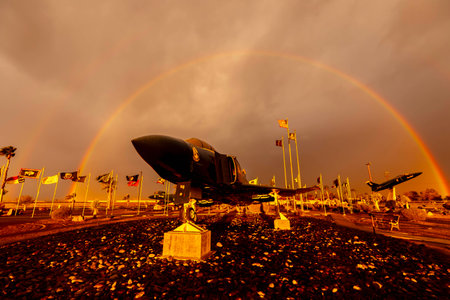 Dawn at Naval Air Field El Centro, CA: Sunlight paints vibrant hues across the sky, casting a...