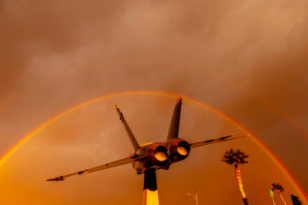 Dawn at Naval Air Field El Centro, CA: Sunlight paints vibrant hues across the sky, casting a...
