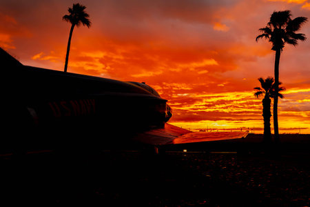 Dawn at Naval Air Field El Centro, CA: Sunlight paints vibrant hues across the sky, casting a...
