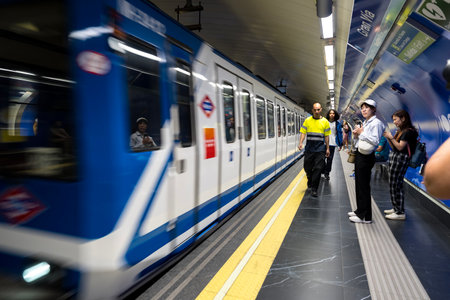 At Almudena Madrid's Puerta de AtochaâAlmudena Grandes station, commuters await trains amidst bustling crowds, immersed in the vibrant rhythm of urban life.のeditorial素材