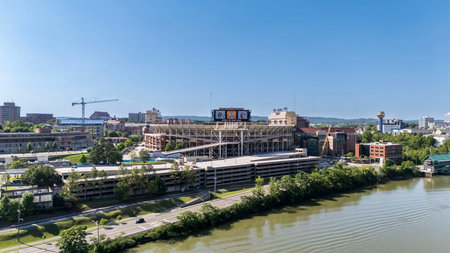An aerial view of Neyland Stadium reveals a massive, iconic structure nestled by the Tennessee River, with its distinctive bowl shape and seating for over 100,000 fans, showcasing its rich football heritage.のeditorial素材