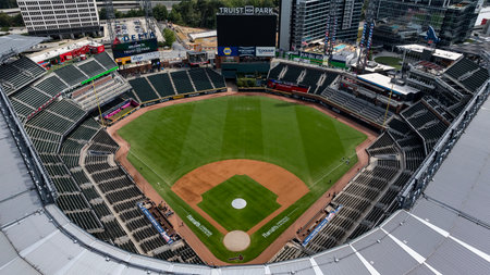 An aerial view of Truist Park showcases a modern baseball stadium nestled in the suburban landscape of Cobb County. Surrounded by The Battery Atlanta, green spaces, and highways, the park blends seamlessly into the bustling Cumberland community, with the のeditorial素材
