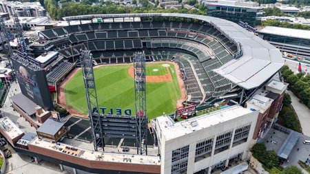 An aerial view of Truist Park showcases a modern baseball stadium nestled in the suburban landscape...