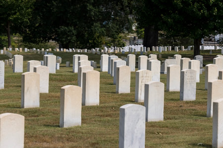 Generic views of a veterans cemetery on a serene day, featuring American flags fluttering in the breeze as a memorial celebration honors those who served.のeditorial素材