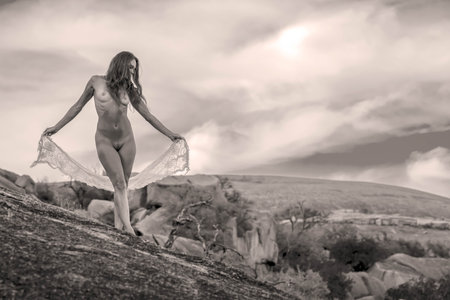 A gorgeous nude brunette model poses outdoors while enjoying the autumn weatherの写真素材