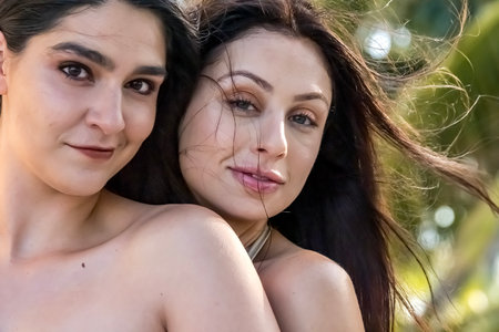 Two gorgeous women embrace their Caribbean vacation, posing for the camera with radiant smiles. Surrounded by stunning scenery, they capture the beauty, adventure, and joy of their unforgettable getaway.の写真素材