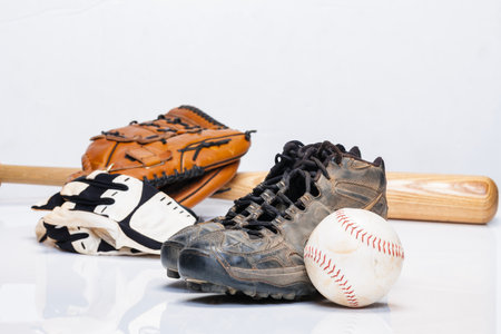 Used baseball cleats against a white background