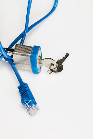 A padlock and keys with ethernet cables showing internet securityの写真素材