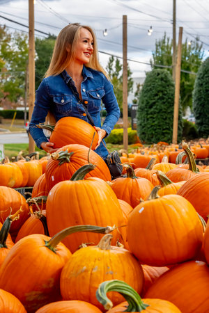 A beautiful European blonde female pics out some pumpkins and flowers for the upcoming fall...