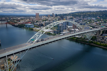 From above, Portlandâ€™s Fremont Bridge arcs over the Willamette River, its sweeping steel...