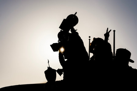 Silhouettes of race winners stand triumphantly in victory lane, trophies raised high as confetti rains down, capturing the thrill and glory after a grueling endurance motorsport battle.の写真素材