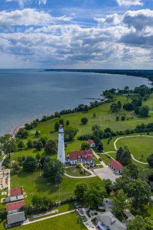 Aerial view of Wind Point Lighthouse, a 108-ft historic beacon on Lake Michiganâs Racine Harbor, standing since 1880 with restored brickwork and a rich maritime legacy.のeditorial素材
