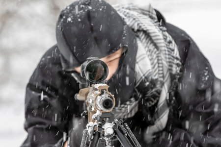 A young soldier trains with his weapon in a harsh snowstorm, braving icy winds and frozen terrain, his focus sharp and determined amid the rugged, wintry outdoor environment.の写真素材